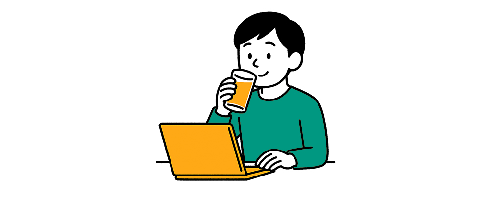 PCを眺めながらジュースを飲む人